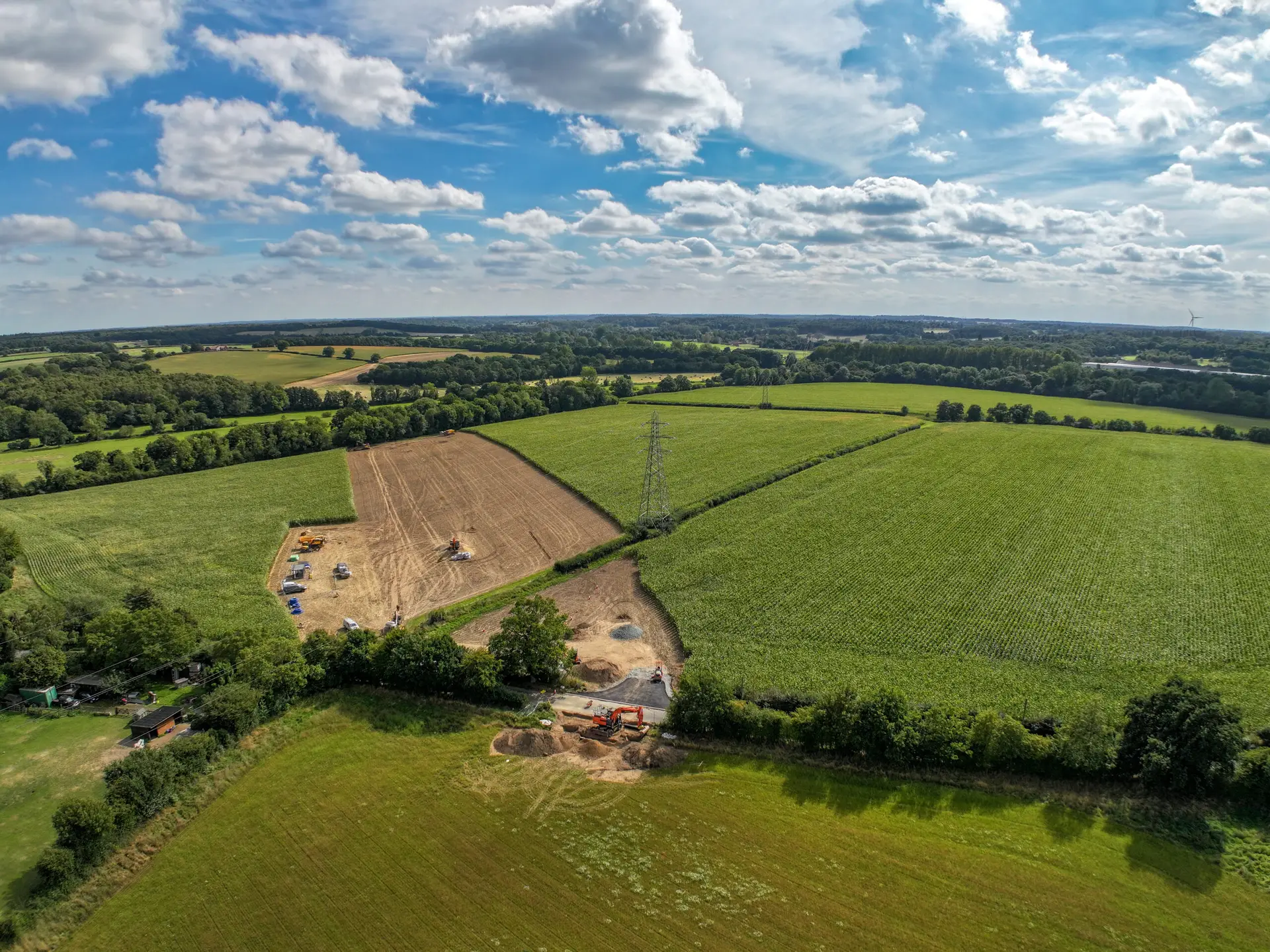 Aerial view of farmland and utility infrastructure, showing land drainage solutions supporting cross-country cable routes