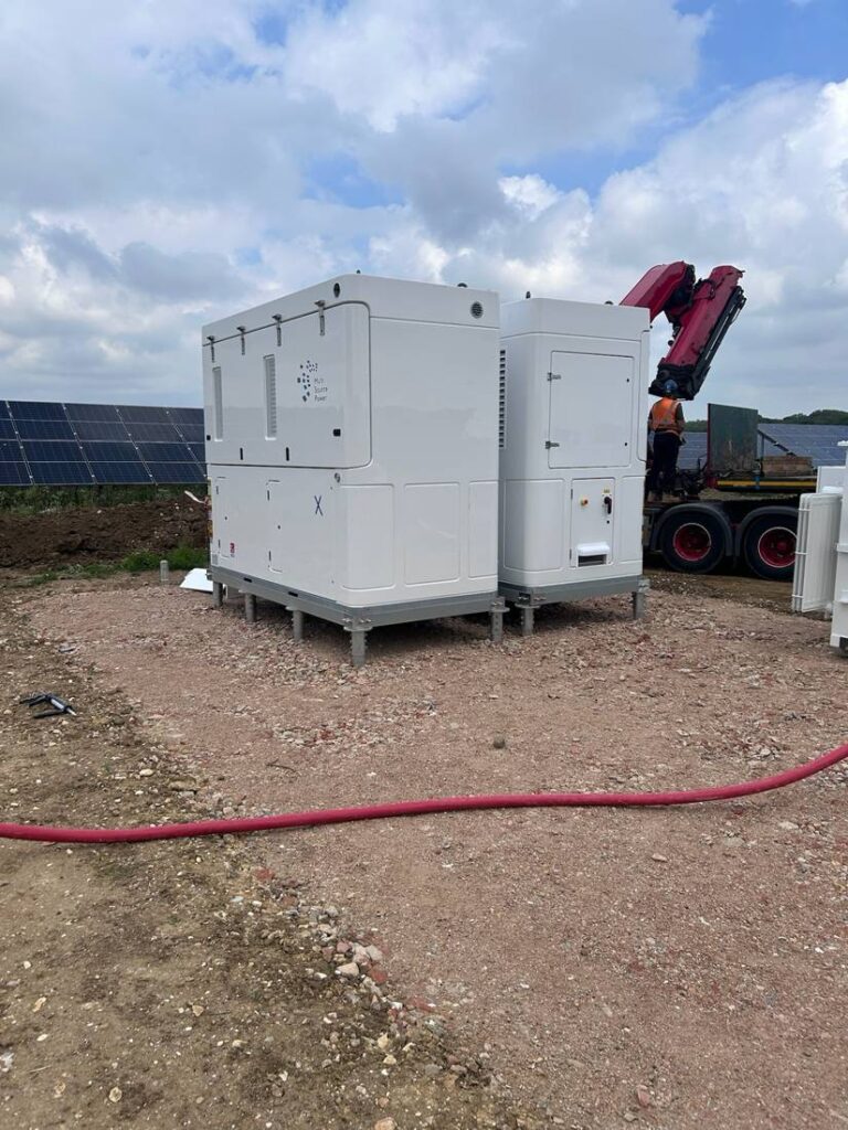 Battery storage units being installed beside the solar array