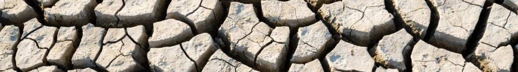 Cracked, parched agricultural land illustrating the impact of prolonged drought conditions on fields in Eastern
