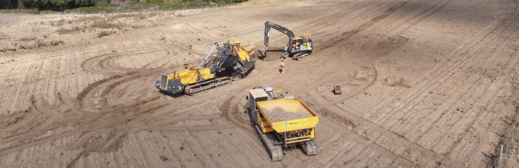 William Morfoot Ltd heavy machinery, including a specialized trenching machine and excavator, working