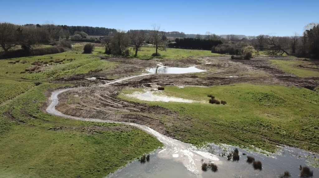 Excavator re-wetting and reconnecting low-lying land to recreate wetland habitat