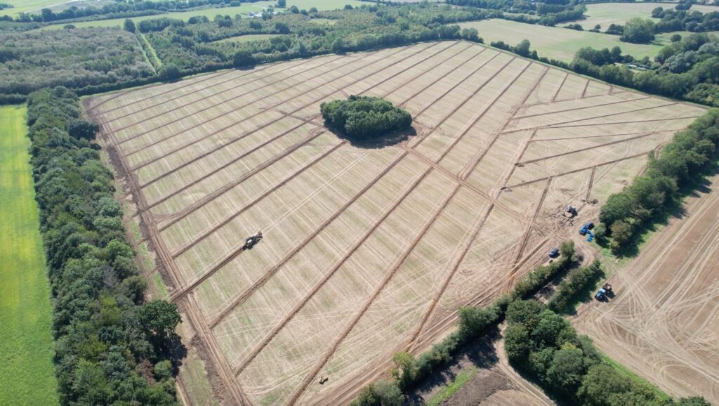 Aerial view of a completed agricultural land drainage scheme showing the systematic layout required to provide effective drainage across an entire field