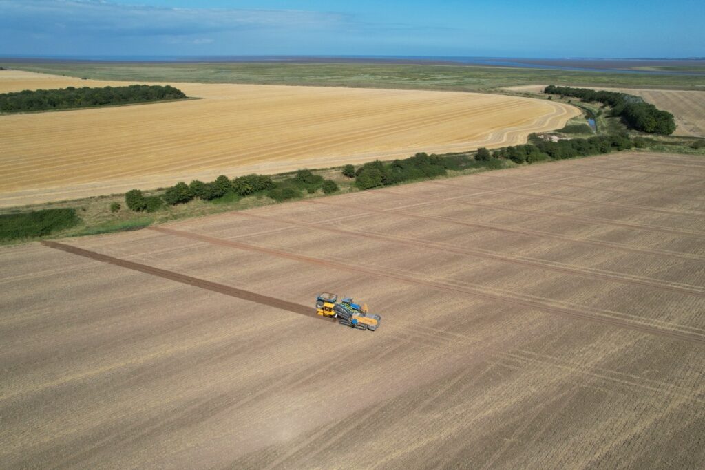 Modern agricultural land drainage installation combining specialist machinery, accurate surveying and experienced operators to achieve precise depths and gradients